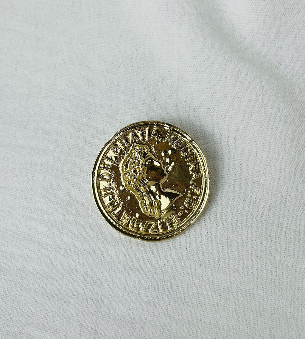 Broche f moneda